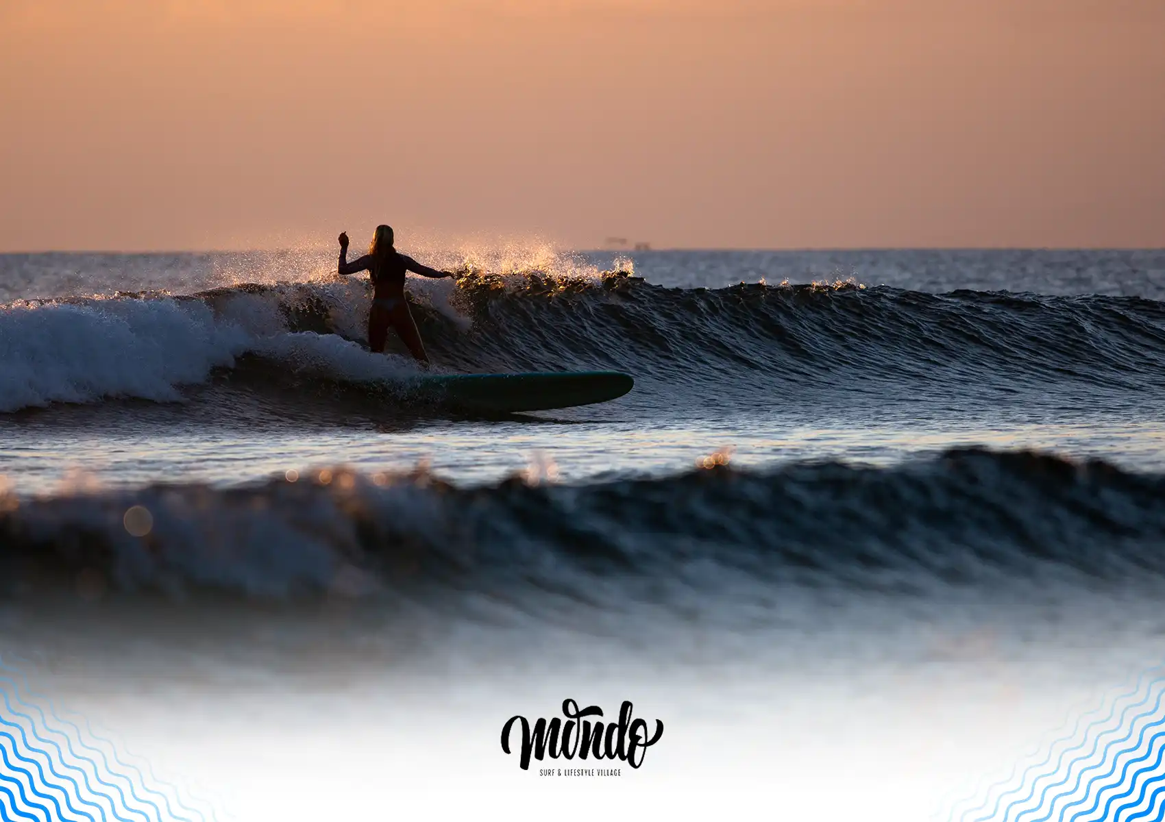 A stunning silhouette of a female surfer gracefully riding a wave on a longboard against a vibrant golden sky, capturing the magic of an early morning session at a surf camp bali.