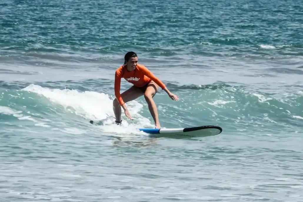 woman standing on surfboard bali