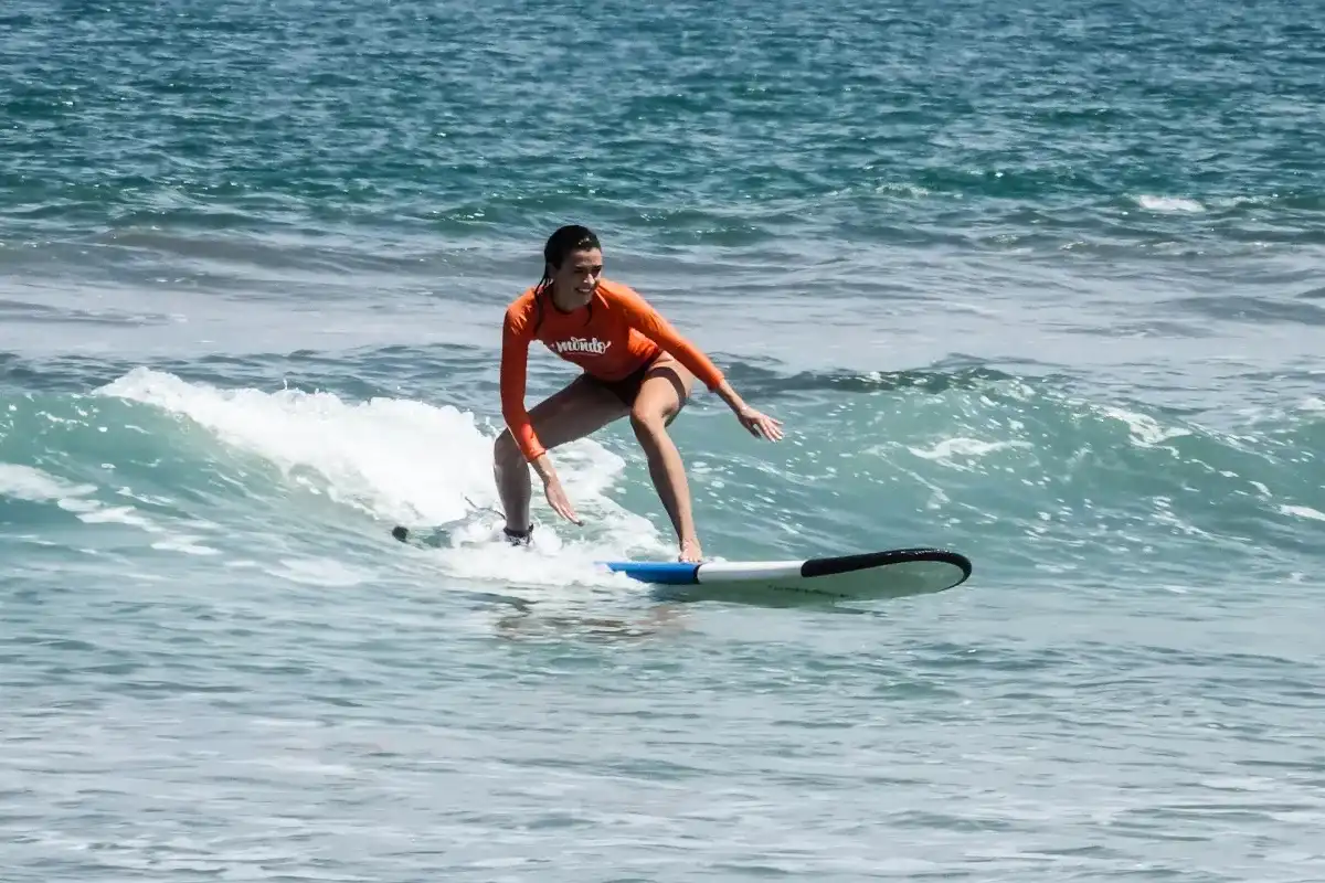 woman standing on surfboard bali