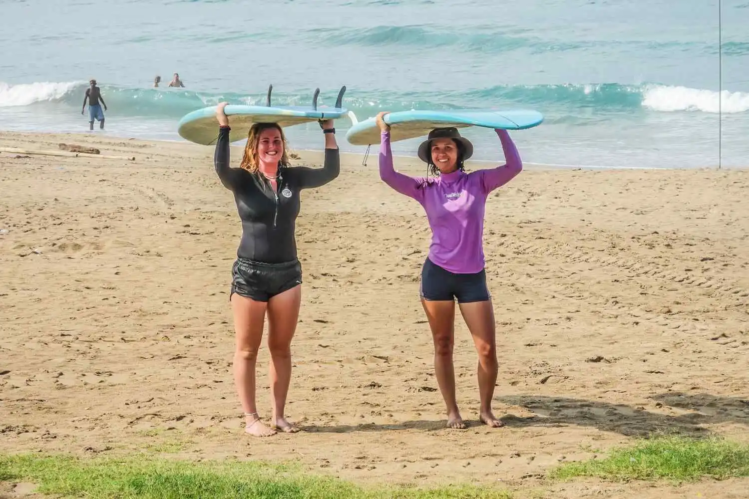 women carrying surfboards surf camp bali