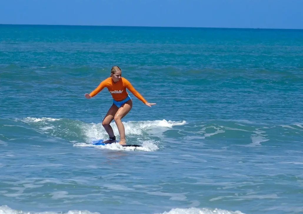 Intermediate surfer practising balance and wave control during a surf camp Bali session.