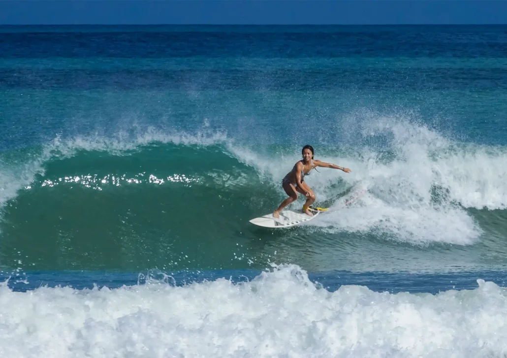 Advanced surfer performing a powerful turn on a clean wave during a surf camp Bali session.