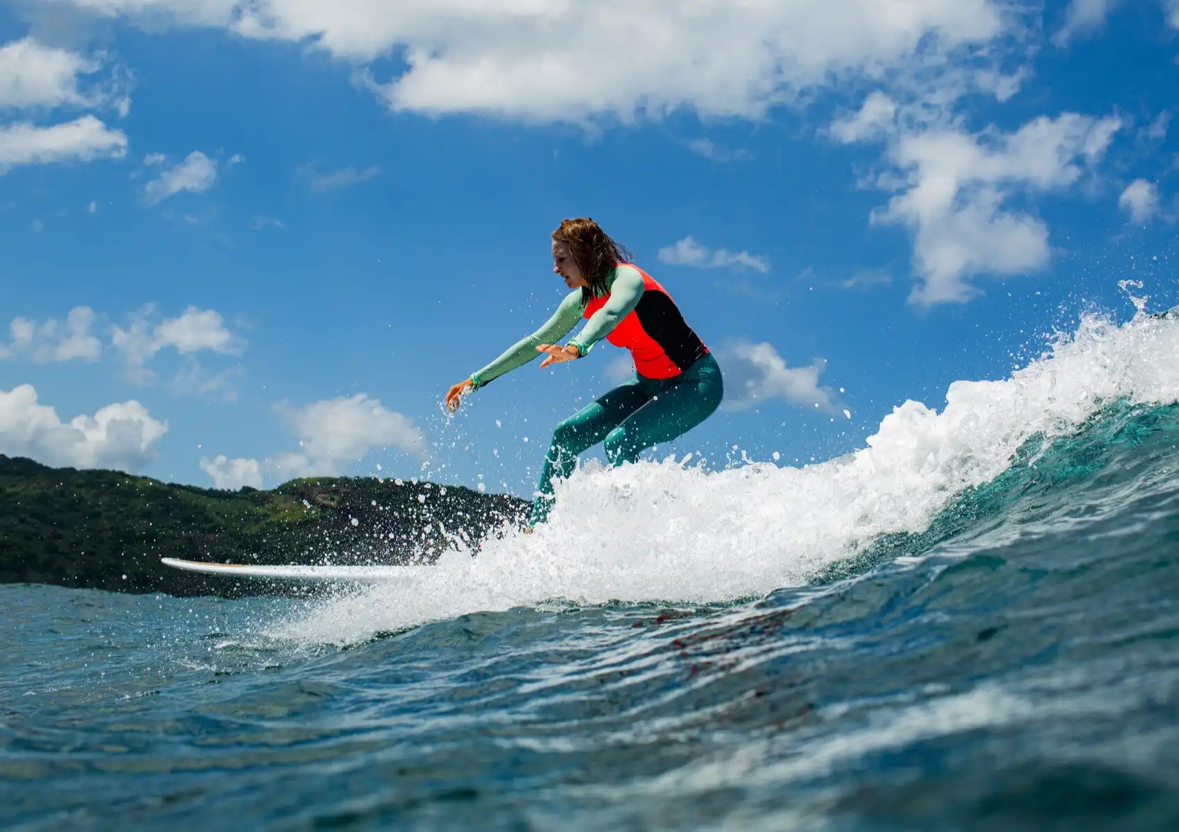 Intermediate surfer riding a funboard wave during a surf camp Bali training session.